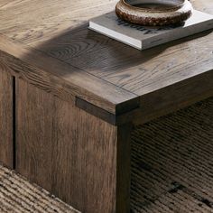 a wooden table with a book and bowl on top