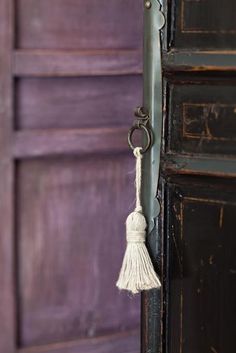 a door handle with a tassel hanging from it