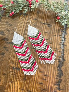 Cute, sparkly and festive holiday earrings! Made with red, green/gold, white and silver seed beads. Finished with sterling silver ear wires. Approx 4 inches length. Feel like the festive little elf that you are in these fun earrings! Please note, I select every bead carefully although some variation in color and size is to be expected. Please expect some mild color variation and don't expect perfect symmetry. Want a different holiday color design? Let's chat! Customizations welcome. Happy Holidays! Handmade Bohemian Beaded Earrings For Christmas, Bohemian Handmade Beaded Christmas Earrings, Bohemian Christmas Dangle Earrings, Bohemian Beaded Earrings For Christmas, Beaded Christmas Earrings, Christmas Beaded Earrings, Perfect Symmetry, Diy Seed Bead Earrings, Beaded Fringe Earrings