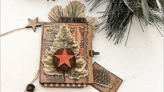 a christmas ornament hanging from the side of a wall next to a pine tree