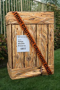 a large wooden box sitting in the grass