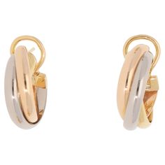 A classic pair of vintage Cartier trinity hoop earrings set in 18k yellow, rose and white gold. Each hoop is set in the iconic trinity design and is composed of three 3-millimetre bands, which are soldered together to create the hoop. They are secured to reverse with a post and omega clip fitting. Due to their size and design these would make a perfect pair of everyday hoop earrings. For the size reference, the hoops each measure approximately 2.0 centimetres in length and 0.7 centimetres in wid Hoop Earring Sets, Antique Jewellery, Yellow Rose, Vintage Cartier, Trinidad, Earrings Set, Cartier, Perfect Pair, Earring Set