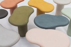 several different colored stools sitting next to each other