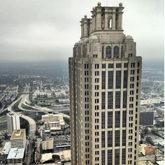 an aerial view of a tall building in the city