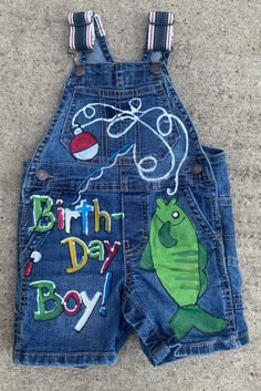 a child's jean shorts with the words birth day boy on it and an image of a fish