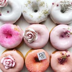 a box filled with lots of different flavored donuts