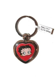 a heart shaped keychain with a cartoon character on it