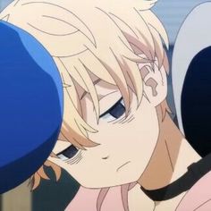 an anime character with blonde hair and blue eyes is looking at something in the distance