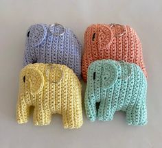 three crocheted elephants are sitting next to each other