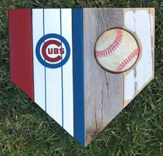 a baseball bat and ball on top of a wooden box with the chicago cubs logo