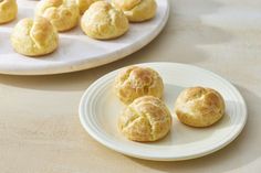 some biscuits are on a white plate next to other pastries