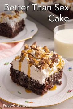 a close up of a piece of cake on a plate with a glass of milk