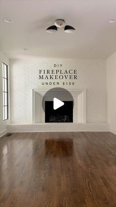 an empty living room with wood floors and fireplace