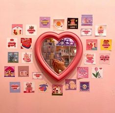 a heart shaped mirror hanging on the side of a wall covered in pictures and magnets