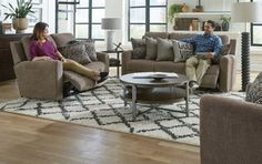 a man and woman sitting on couches in a living room