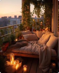 a balcony with lots of candles and plants on the floor, all lit up at night