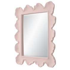 a pink mirror with scalloped edges on a white wall and the reflection in it