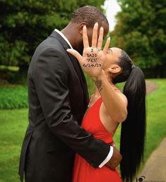 a man and woman kissing in front of trees with the words i love you canada written on their fingers