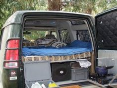 there is a bed in the back of an suv