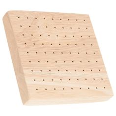 a wooden peg board with holes in it