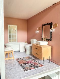 a doll house bathroom with sink, toilet and mirror