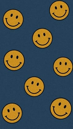 many yellow smiley faces are arranged in rows on a dark blue background with black dots