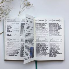 an open book with some type of text on the page and flowers in the background