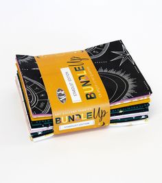 four books stacked on top of each other in front of a white background with black and yellow designs