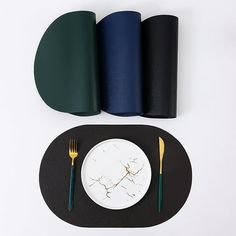 there is a plate, fork and knife on the placemat next to two napkins