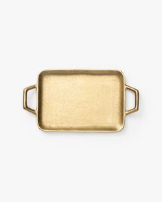 an antique brass tray with handles on a white background, it is isolated from the side