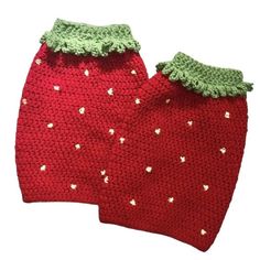 two crocheted strawberries are sitting next to each other