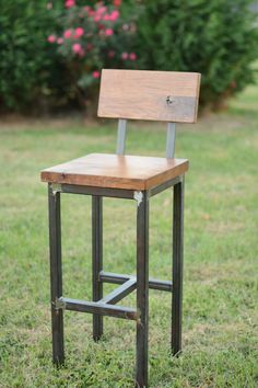 a wooden chair sitting on top of a lush green field