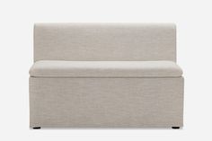 an upholstered couch with a white back and black legs, against a gray background