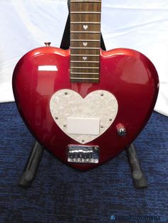 a red guitar with a white heart on it