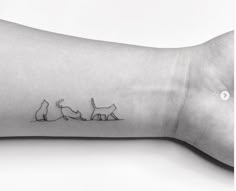 a cat and dog tattoo on the wrist