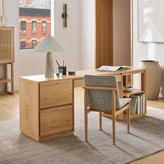 a desk with a chair, lamp and bookshelf