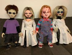 three dolls are sitting on a couch with their faces painted white and wearing zombie makeup