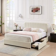 a white bed with two drawers underneath it