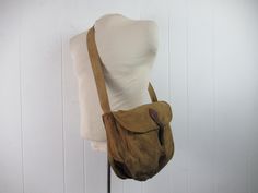 "Vintage 1910s or 20s across the chest shoulder bag, fishing creel, hunting bag. Made of canvas and leather. Made for trout fishing, but is very versitile. Has one main compartment with buckle closue(buckle is broken off - see picture) and copper screen bottom. No label, but leather is branded \"14\". Bag measures 9\" tall, 12\" wide and 4\" thick. In good condition with original dirt, I have not tried to clean." Vintage Shoulder Bag For Outdoor, Vintage Canvas Shoulder Bag For Outdoor, Vintage Shoulder Bag With Adjustable Strap For Adventure, Vintage Canvas Bag With Adjustable Strap For Outdoor, Vintage Brown Shoulder Bag For Adventure, Vintage Canvas Satchel For Outdoor, Vintage Waxed Canvas Shoulder Bag With Adjustable Strap, Vintage Satchel Shoulder Bag With Canvas Lining, Vintage Brown Canvas Bag For Outdoor