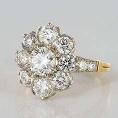 an antique diamond cluster ring in yellow gold