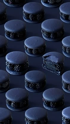 rows of black cakes with frosting on them