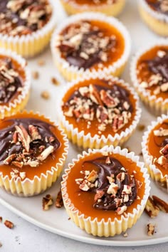 there are many cupcakes with chocolate and nuts on the top one is covered in caramel