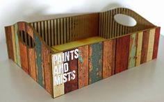 a wooden box with paint's and mists written on the side in white letters