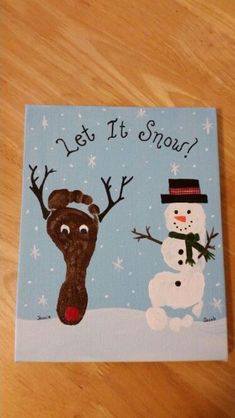 a painting of a snowman and a reindeer with the words let it snow