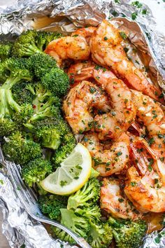 shrimp and broccoli wrapped in foil with lemon wedges