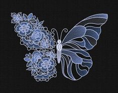 an embroidered butterfly with blue flowers on it's wings, sitting on a black background