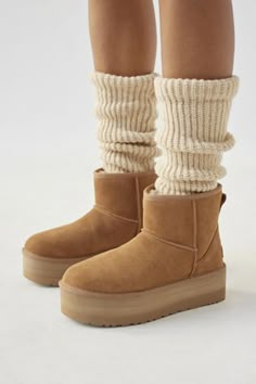 A modern interpretation of UGG’s icon, this Classic Mini boot reaches new heights with a leg-lengthening platform. Offering a bolder look than ever before, it's made with the same rich suede as the original, plus the 17mm UGGplush™ wool blend for signature softness. Overlock seam stitching, recycled polyester binding and a leather heel label with embossed UGG® logo. Content + Care Suede, UGGplush™ (upcycled wool, lyocell), EVA, rubber Spot clean Imported Size + Fit True to size Platform height: Uggs Ankle Boots, Ugg Classic Mini Platform Boots Outfit, Ugh Platform Boots, Ugh Classic Mini Platform Outfit, Platform Ugg Mini, Classic Mini Platform Ugg, Ugh Mini Platform, Classic Mini Platform Uggs Outfit, Mini Uggs Platform