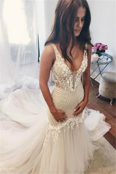 a pregnant woman in a wedding dress