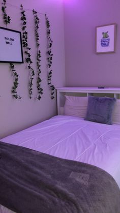 there is a bed with purple comforter and pillows in the room that has ivy growing on the wall