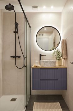 a bathroom with a sink, mirror and shower head in the corner next to a rug